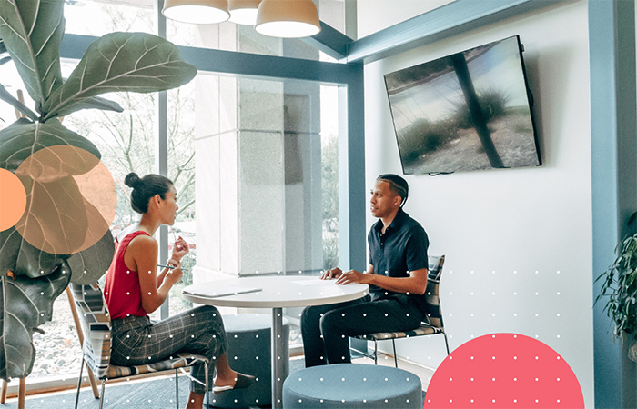 Leader giving feedback to staff member using the changing your lens approach.